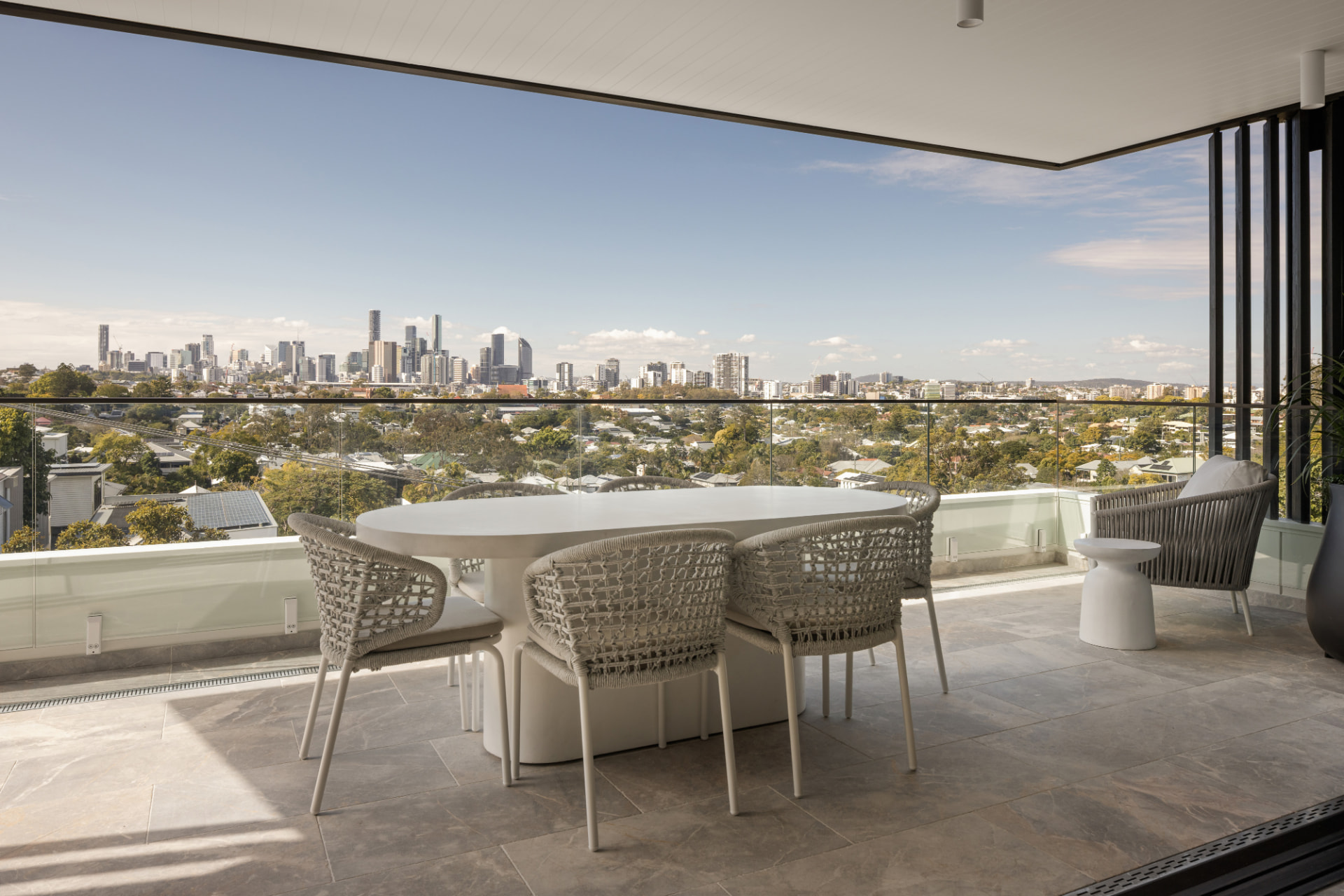 Covered terrace dining with Brisbane skyline views