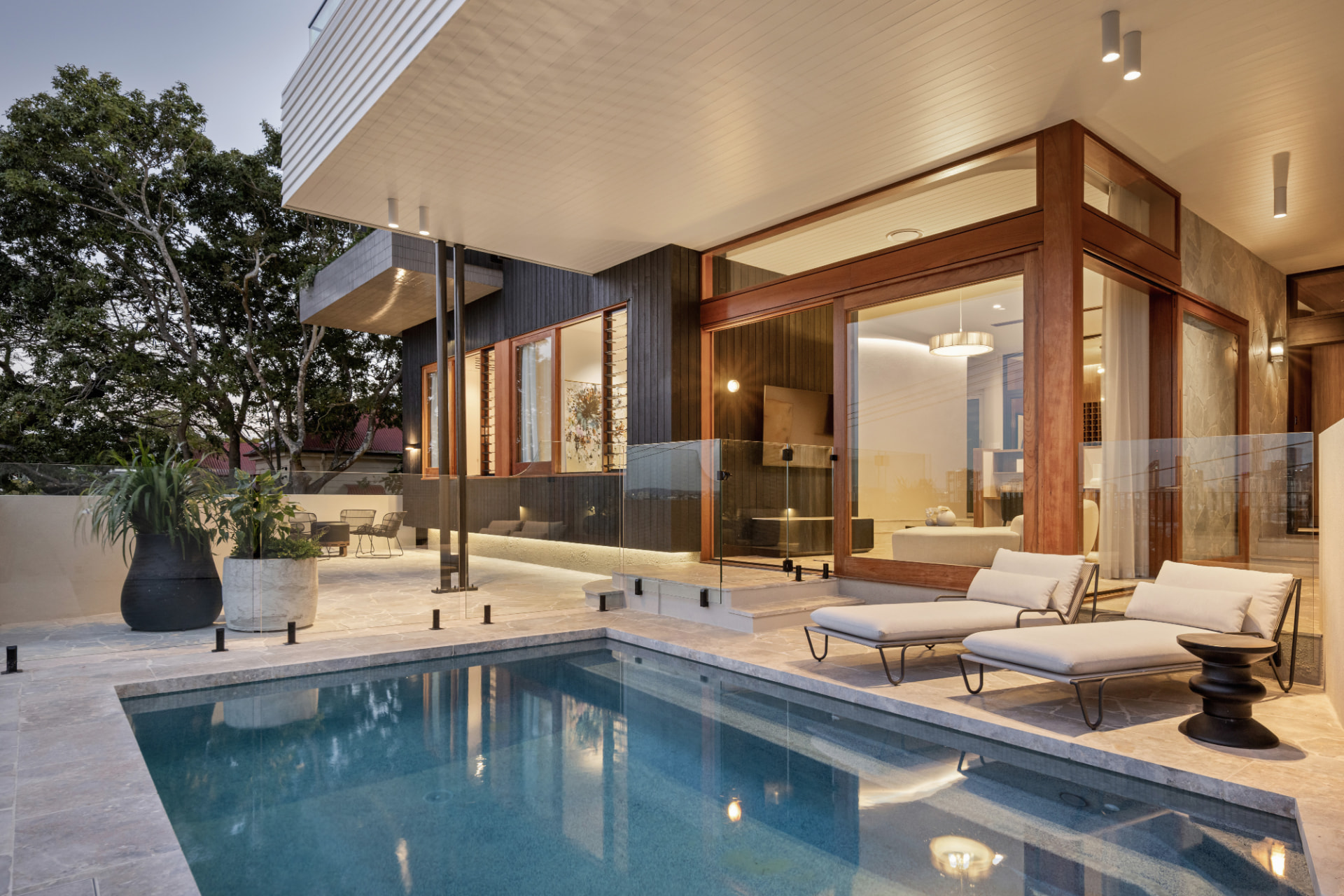 Pool terrace and living pavilion at dusk