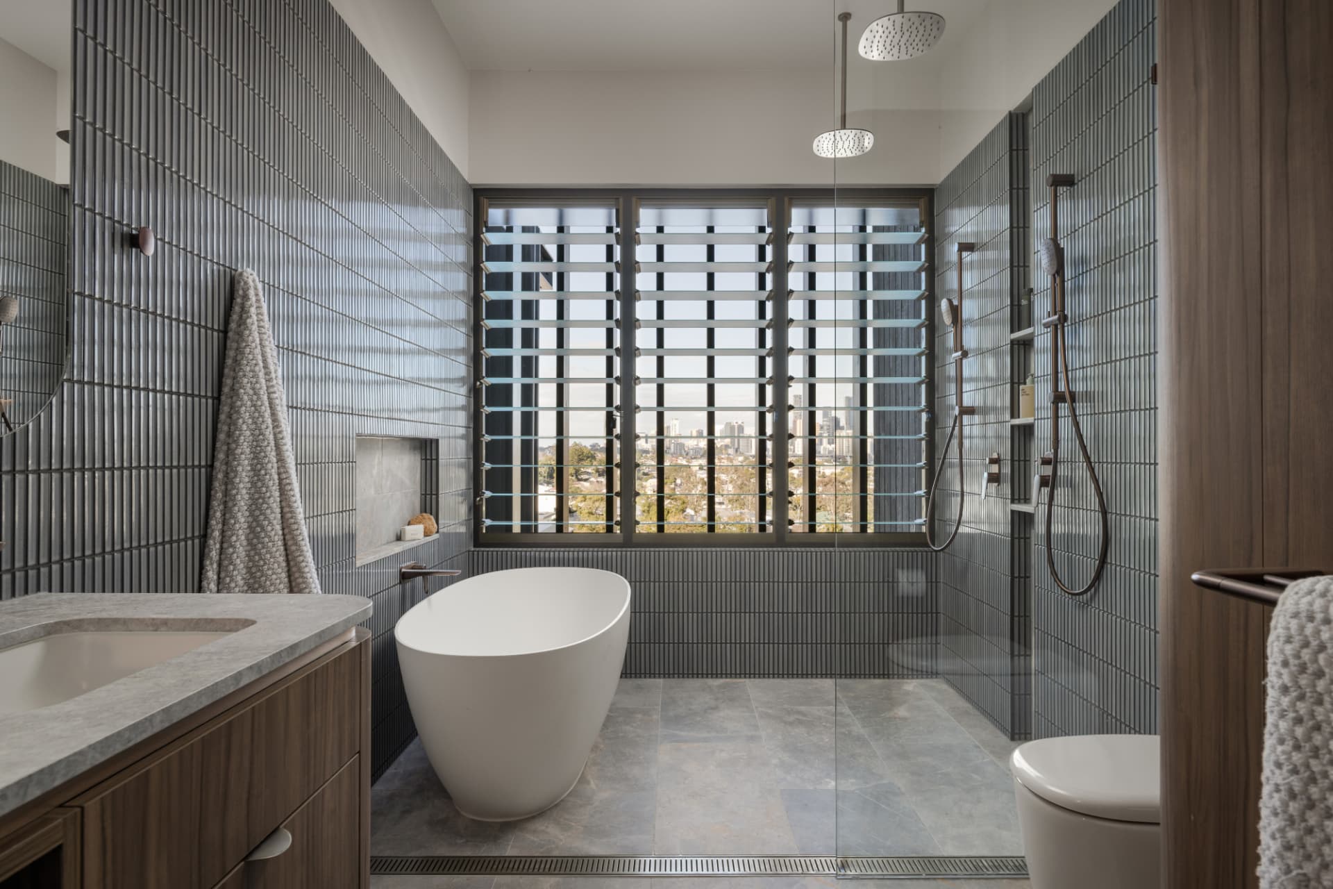 Ensuite with freestanding stone bath and city outlook