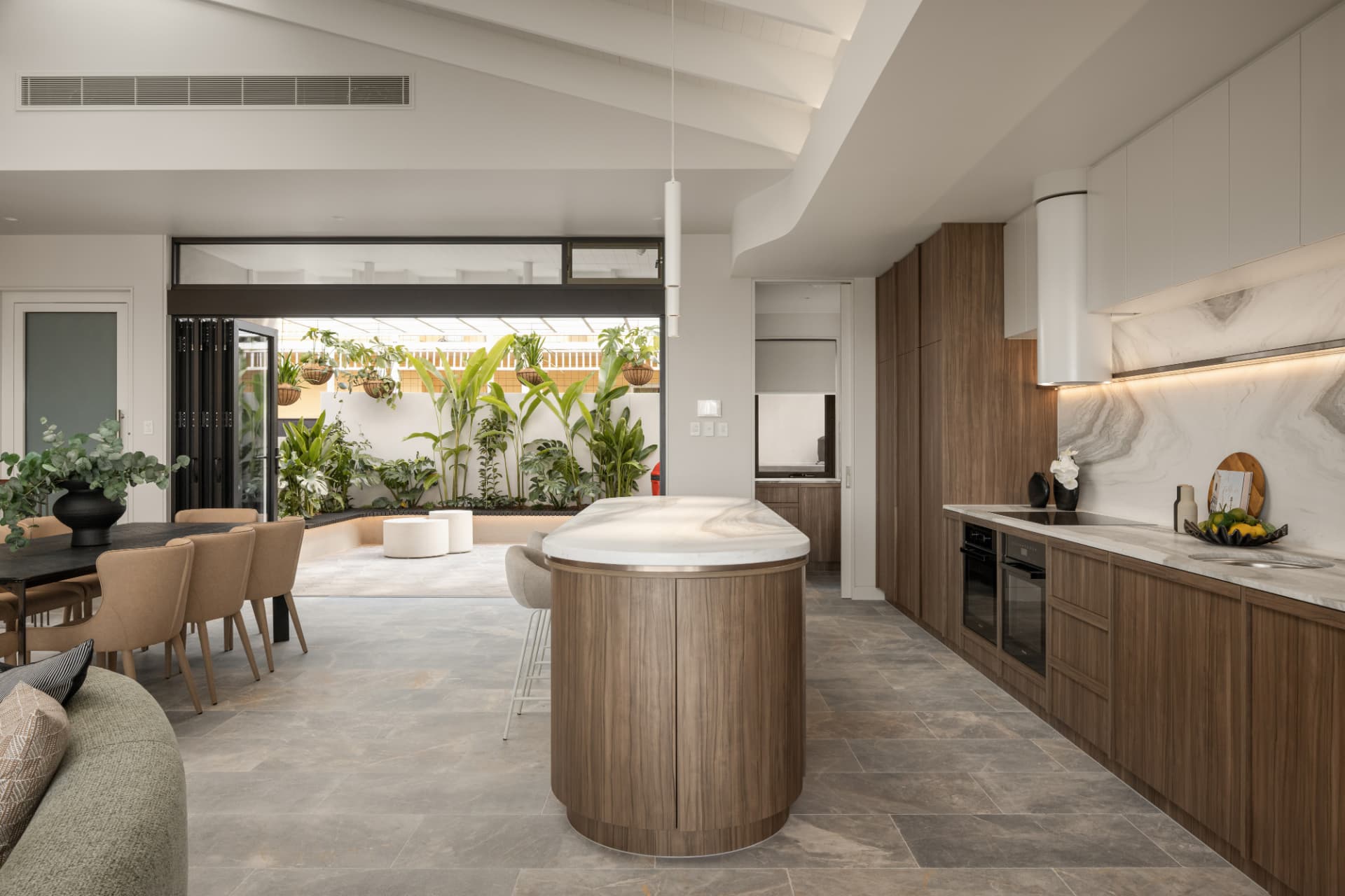Open plan kitchen and dining flowing to the tropical courtyard