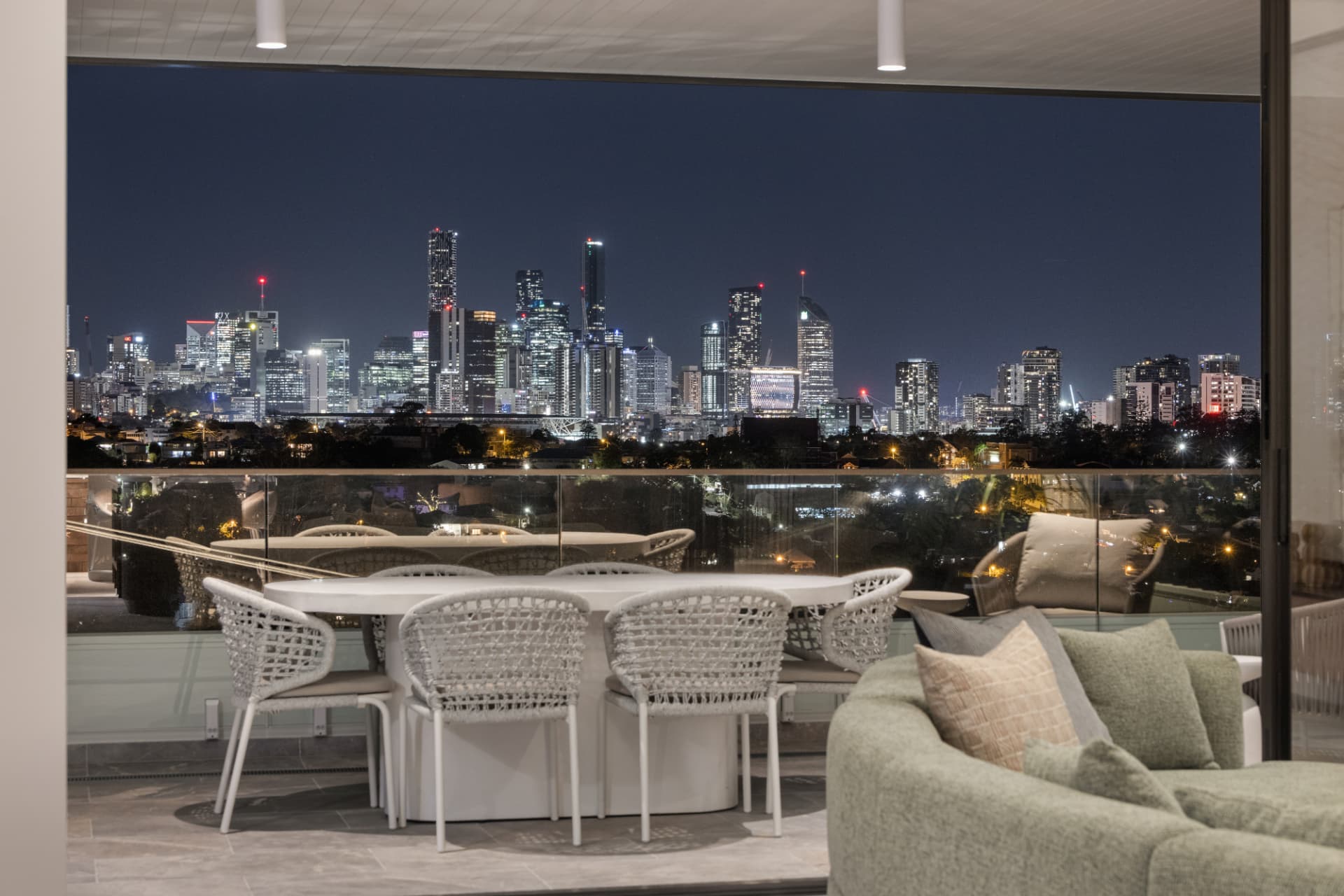 Terrace dining with the city skyline lit at night