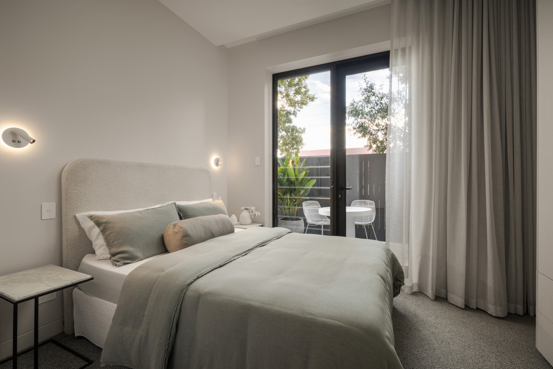 Guest bedroom opening to a private courtyard terrace